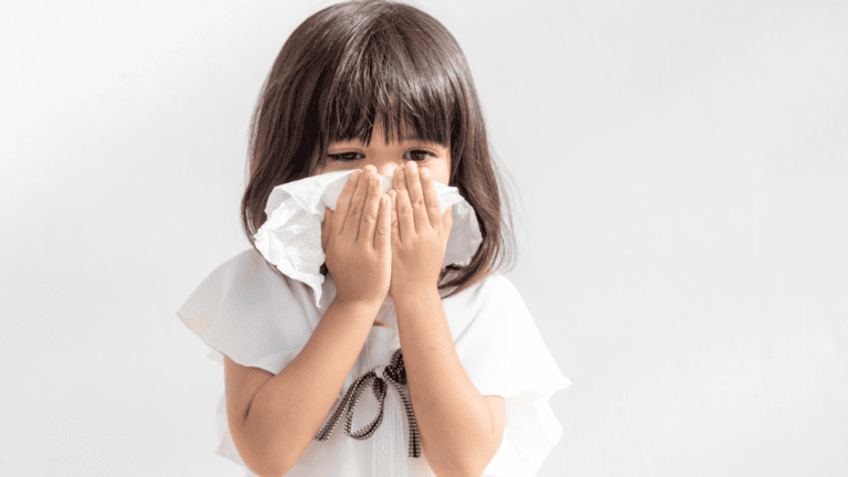 Girl blowing nose